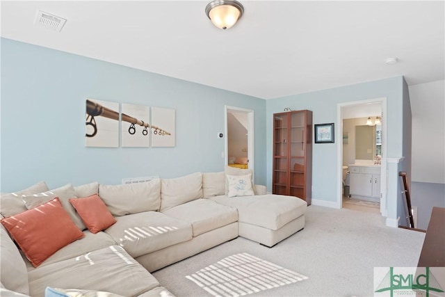 living area with carpet, visible vents, and baseboards