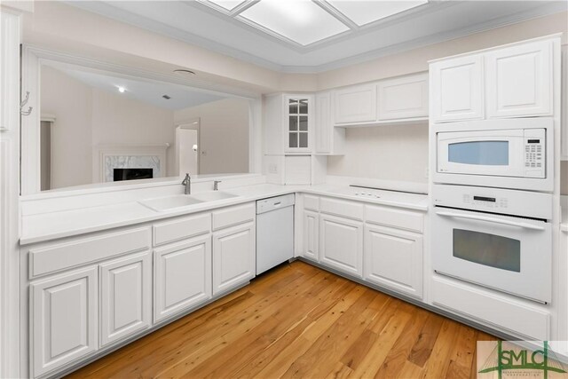 16 Oak Park Pt, Savannah, GA 31405 - kitchen with a sink, light countertops, white appliances, and white cabinetry