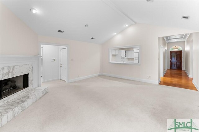 16 Oak Park Pt, Savannah, GA 31405 - unfurnished living room featuring attic access, visible vents, vaulted ceiling, baseboards, and light carpet