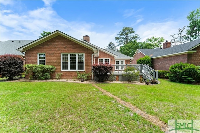16 Oak Park Pt, Savannah, GA 31405 - back of property featuring a yard, brick siding, a chimney, and a wooden deck