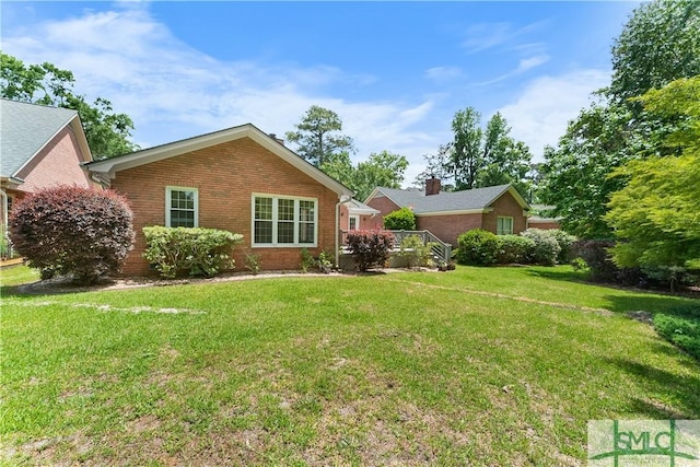 16 Oak Park Pt, Savannah, GA 31405 - rear view of house featuring a yard and brick siding