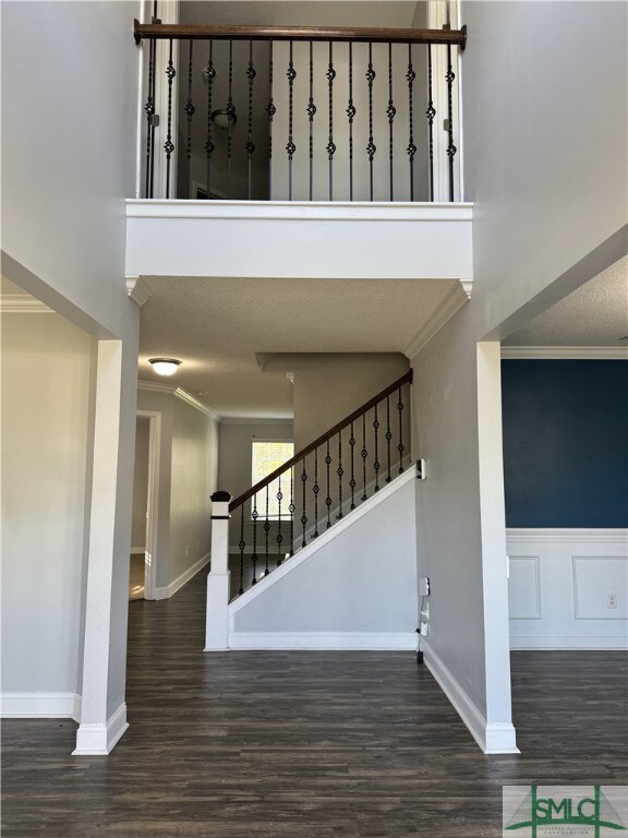 204 Grandview Dr, Hinesville, GA 31313 - stairway featuring a towering ceiling, crown molding, and wood finished floors