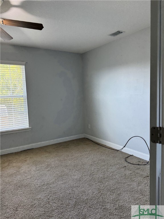 204 Grandview Dr, Hinesville, GA 31313 - spare room featuring visible vents, ceiling fan, carpet, and baseboards