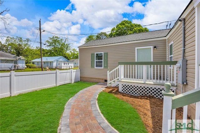 view of yard with fence and a deck