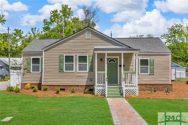 bungalow-style house featuring crawl space, a shingled roof, and a front yard