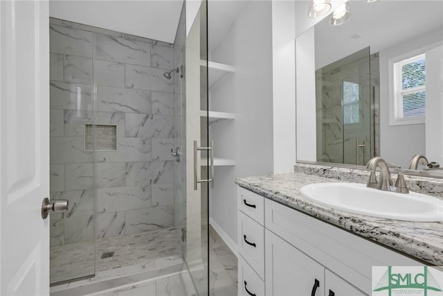 bathroom featuring vanity, baseboards, a stall shower, and marble finish floor