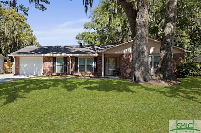 single story home with a garage, a front yard, and brick siding
