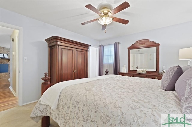 bedroom with light carpet, baseboards, and a ceiling fan