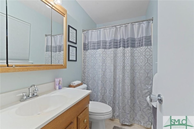 bathroom featuring toilet, vanity, and a shower with shower curtain
