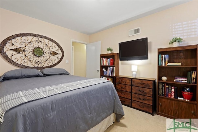 carpeted bedroom featuring visible vents