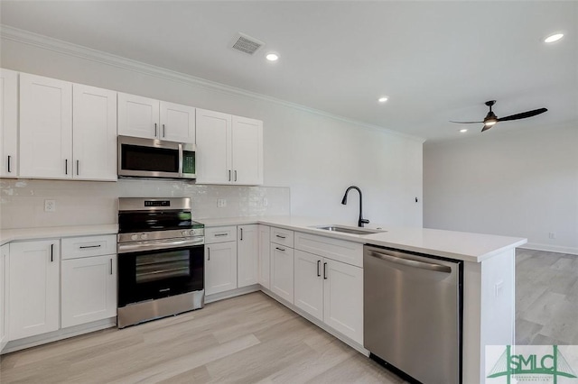 1615 Le Grand St, Savannah, GA 31401 - kitchen with a peninsula, a sink, visible vents, ceiling fan, and appliances with stainless steel finishes