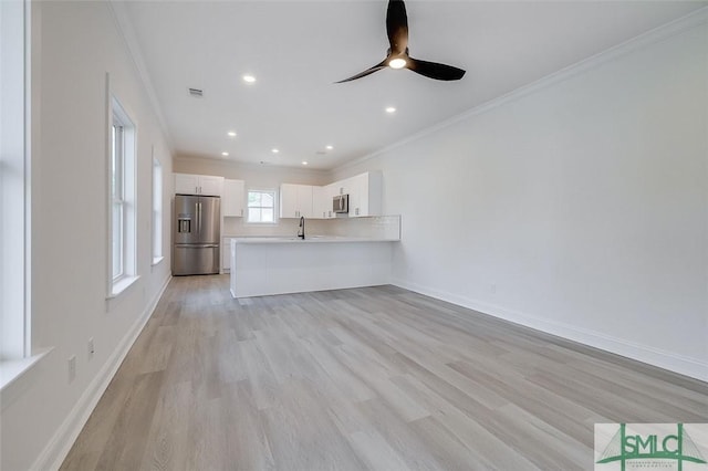1615 Le Grand St, Savannah, GA 31401 - unfurnished living room with recessed lighting, visible vents, light wood finished floors, and ornamental molding
