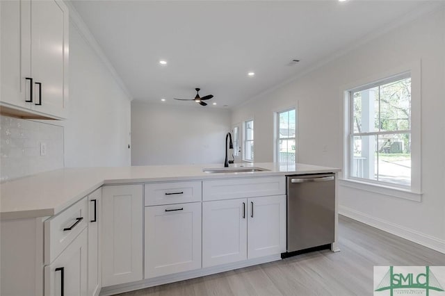 1615 Le Grand St, Savannah, GA 31401 - kitchen featuring a sink, light wood-style flooring, dishwasher, light countertops, and white cabinets