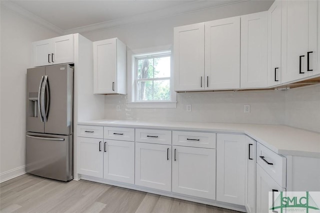 1615 Le Grand St, Savannah, GA 31401 - kitchen featuring light wood-style flooring, backsplash, white cabinetry, stainless steel fridge with ice dispenser, and ornamental molding