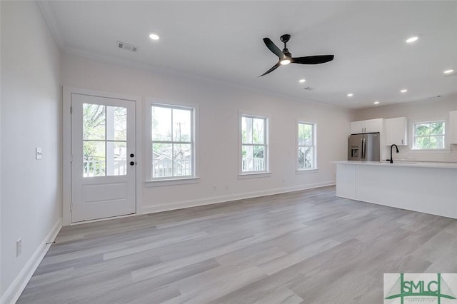 1615 Le Grand St, Savannah, GA 31401 - unfurnished living room with baseboards, visible vents, light wood-style floors, and ornamental molding