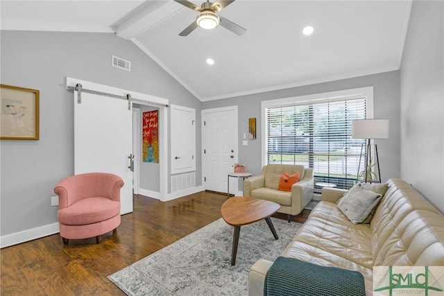 living room featuring a barn door, wood finished floors, visible vents, and baseboards