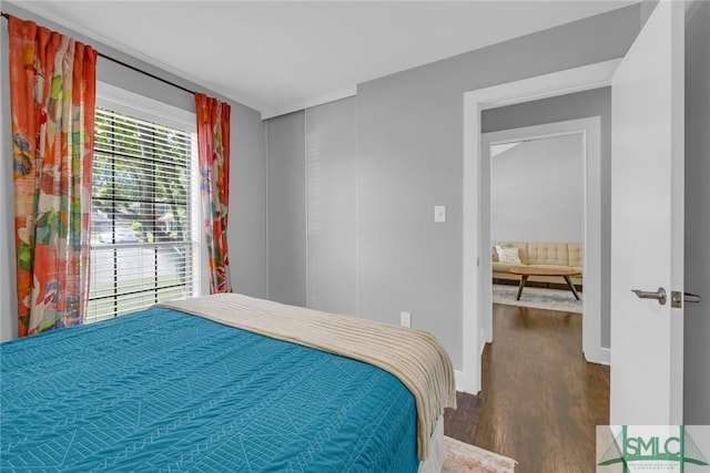 bedroom with baseboards and wood finished floors