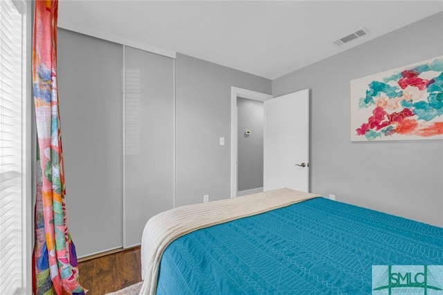 bedroom with wood finished floors and visible vents