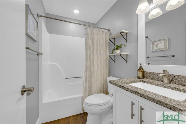 bathroom featuring shower / bath combo, toilet, vanity, and wood finished floors