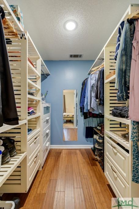 spacious closet with visible vents and light wood-style flooring