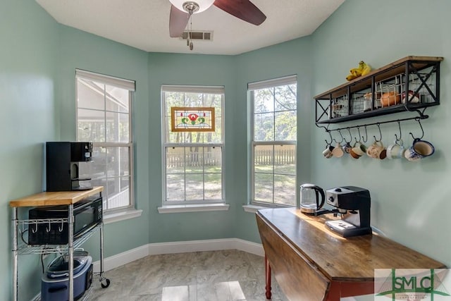 doorway to outside with ceiling fan, baseboards, and visible vents