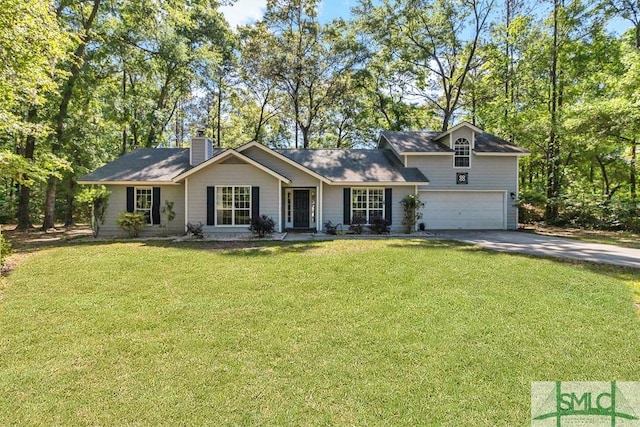 view of front of home featuring an attached garage, driveway, a chimney, and a front yard