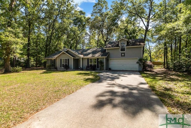view of front of home with an attached garage, driveway, and a front lawn