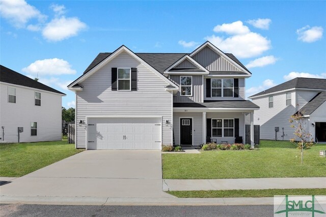 craftsman house with driveway, a front yard, board and batten siding, and a garage