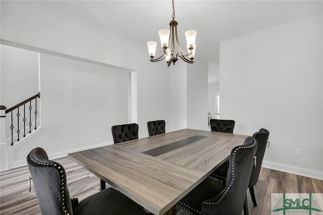 dining space with stairway, baseboards, a notable chandelier, and dark wood-style floors