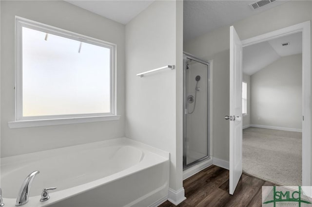 full bath with a bath, visible vents, and a healthy amount of sunlight