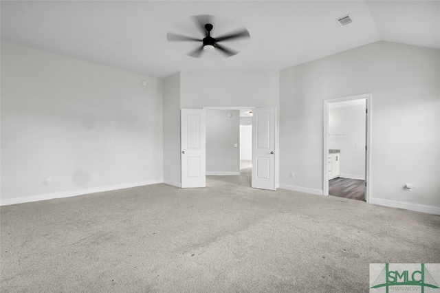 unfurnished bedroom with visible vents, baseboards, vaulted ceiling, and carpet flooring