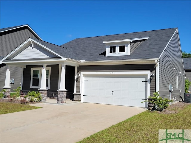 craftsman-style house with stone siding, driveway, a garage, and covered porch