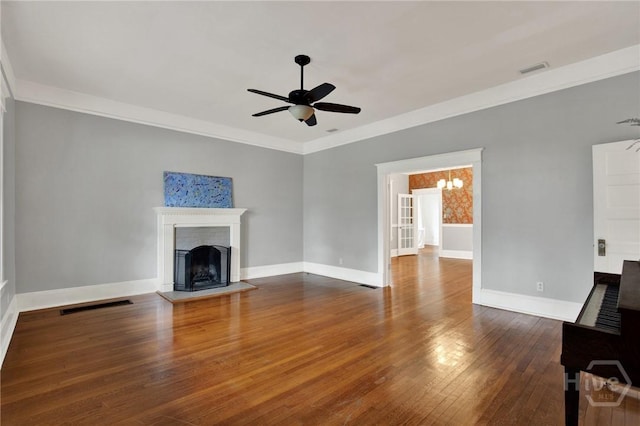 128 E 48th St, Savannah, GA 31405 - unfurnished living room with a fireplace with raised hearth, a ceiling fan, hardwood / wood-style flooring, and crown molding