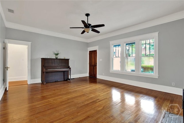 128 E 48th St, Savannah, GA 31405 - unfurnished living room with ceiling fan, wood finished floors, and crown molding