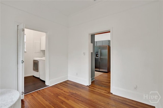 128 E 48th St, Savannah, GA 31405 - spare room featuring washer and clothes dryer and wood finished floors