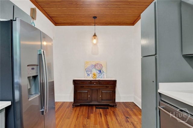 128 E 48th St, Savannah, GA 31405 - kitchen with appliances with stainless steel finishes, wood ceiling, dark wood-style floors, light countertops, and pendant lighting