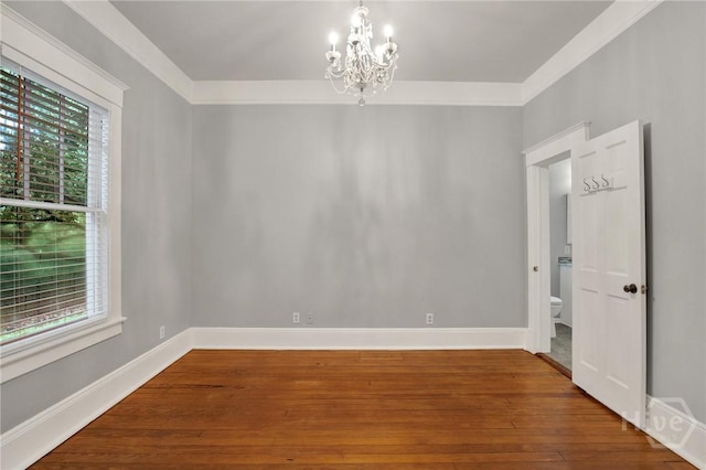 128 E 48th St, Savannah, GA 31405 - spare room with healthy amount of natural light, a chandelier, wood-type flooring, and crown molding