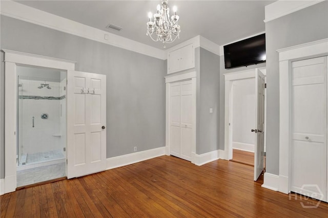 128 E 48th St, Savannah, GA 31405 - unfurnished bedroom with a chandelier, hardwood / wood-style flooring, and connected bathroom