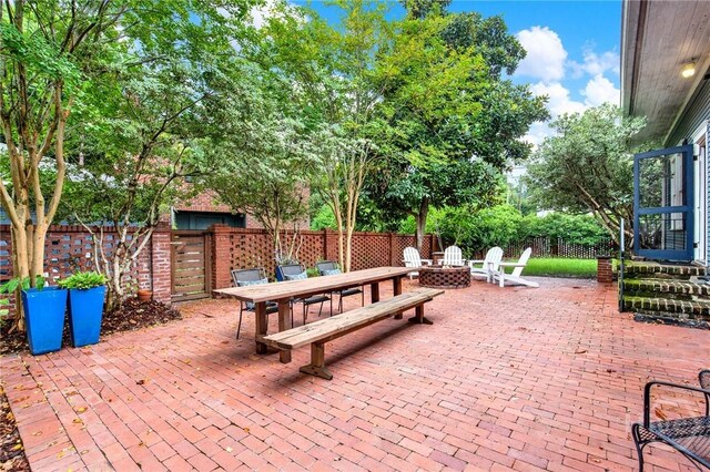 128 E 48th St, Savannah, GA 31405 - view of patio / terrace with a fire pit and outdoor dining space
