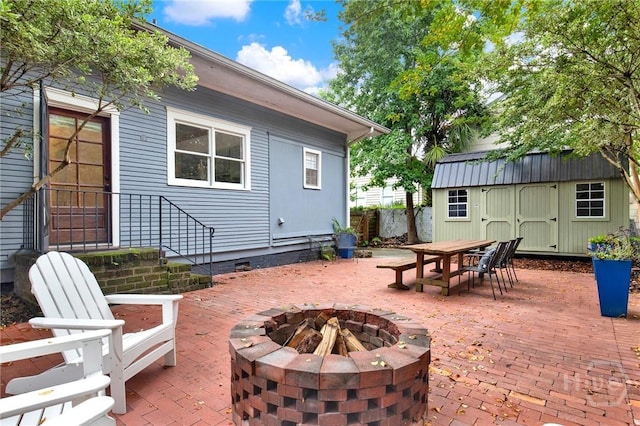128 E 48th St, Savannah, GA 31405 - view of patio with a fire pit, a storage shed, and outdoor dining area
