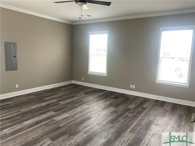 unfurnished room with a ceiling fan, electric panel, baseboards, ornamental molding, and dark wood-style floors