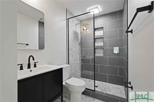 bathroom with toilet, walk in shower, and vanity