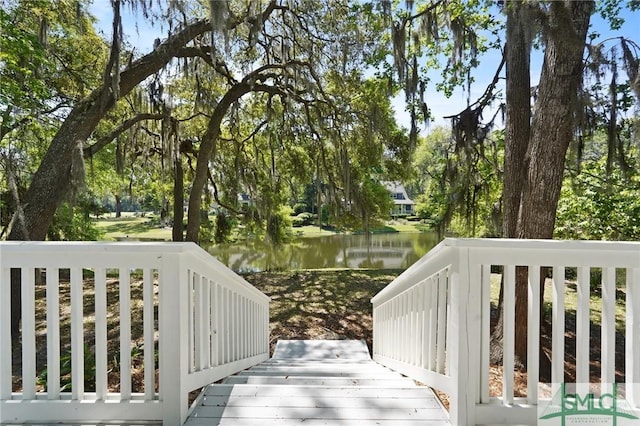 wooden deck featuring a water view