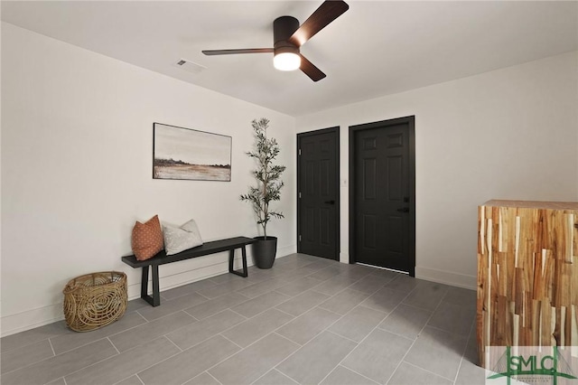 entryway featuring visible vents, baseboards, and a ceiling fan