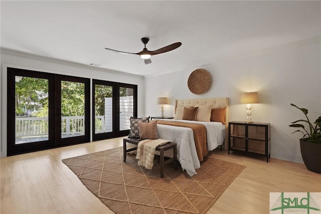 bedroom featuring light wood finished floors, a ceiling fan, visible vents, and access to exterior