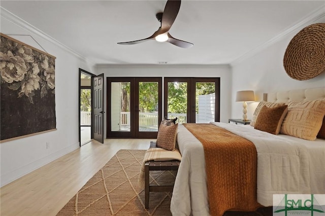 bedroom featuring french doors, wood finished floors, ornamental molding, a ceiling fan, and access to outside