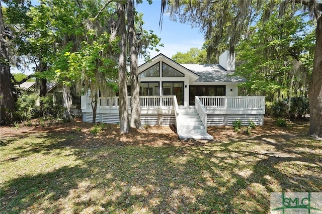 back of house with stairway and a lawn