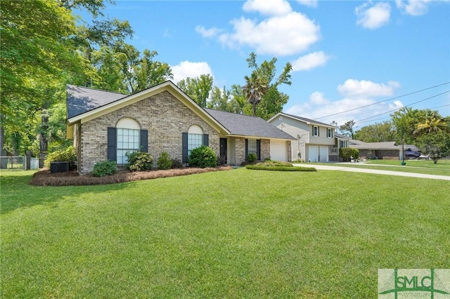 view of front of property with brick siding, driveway, a front yard, and a garage
