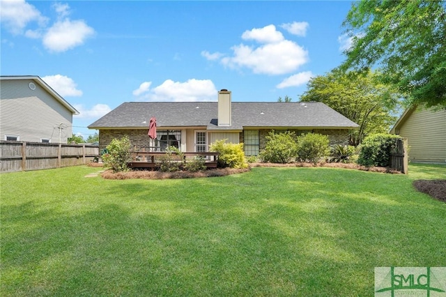back of house featuring a lawn, fence, and a deck