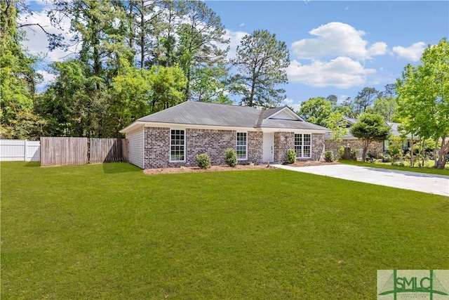 ranch-style home with a front lawn and fence